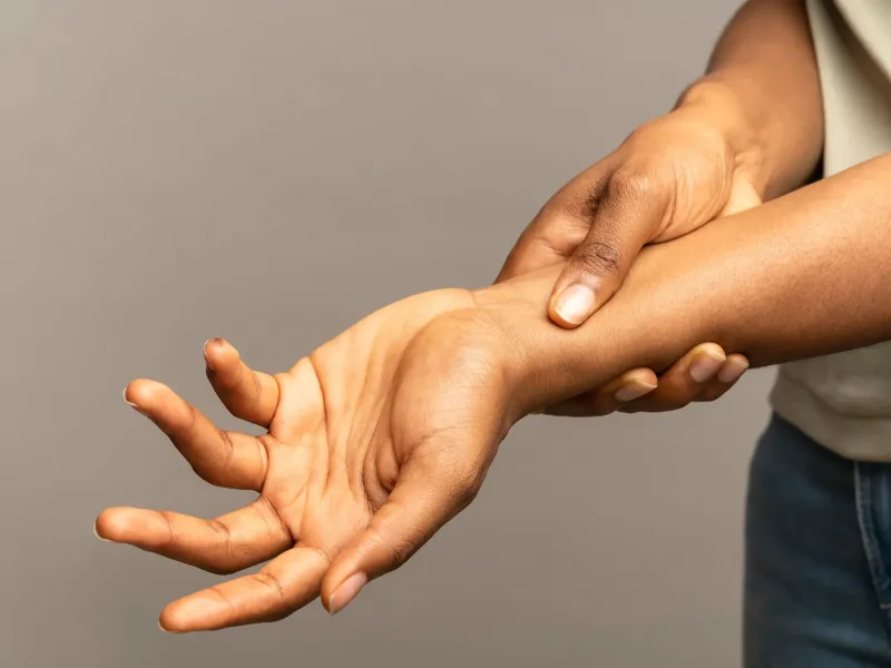 Woman holding painful wrist