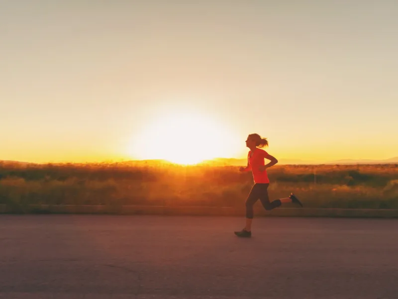 Woman running at sunset